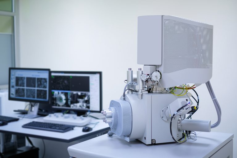 Scanning Electron Microscope (SEM) machine in laboratory and blur computer controller background
